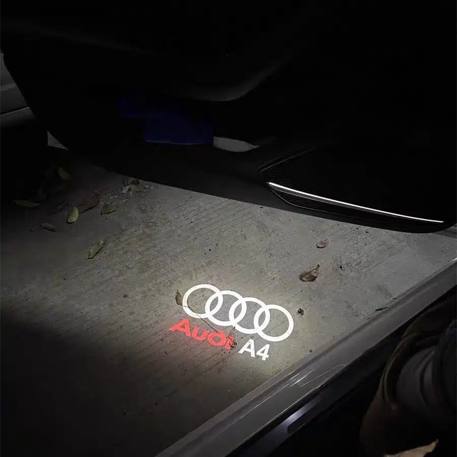 audi a4 puddle lights Audi A4 logo illuminated door light projecting the brand emblem onto the ground when the car door is opened.