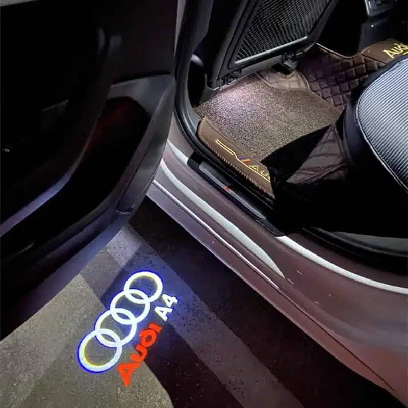 audi a4 puddle lights LED light featuring the Audi A4 logo, designed to project the emblem onto the ground as a car door opens.