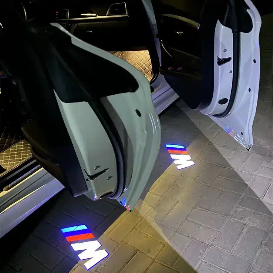 BMW M Puddle Lights BMW M door puddle lights casting bright emblem on wet street surface, ideal for UK driving conditions