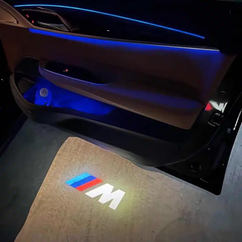 BMW M Puddle Lights Close-up of BMW M puddle lights illuminating pavement with crisp logo projection, UK market accessory
