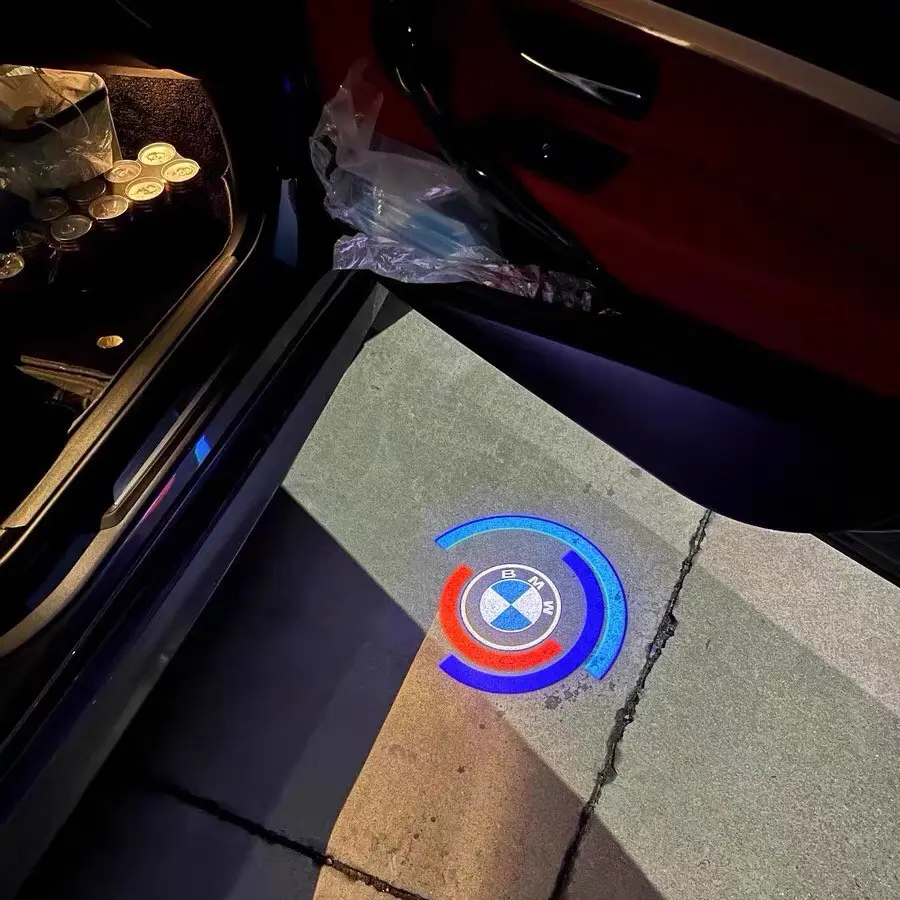 BMW 50th Anniversary Door Lights ED car door puddle lights featuring the BMW 50 Years of M anniversary emblem projected onto the ground.