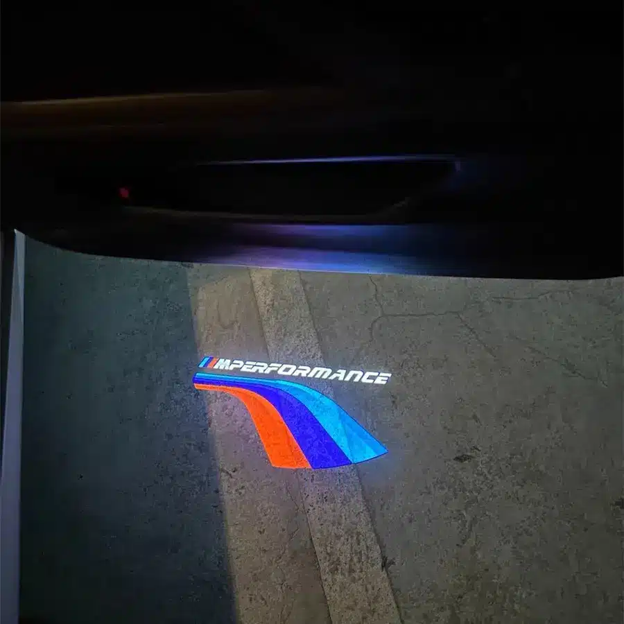 M Sport Puddle Lights Close-up of the BMW logo affixed to a car door, representing the brand's commitment to quality and performance.